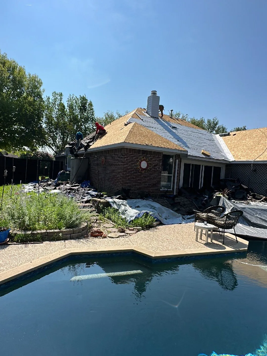 Backyard, pool side view of a beautiful north Texas home with the roof recently replaced by MD roofing and construction